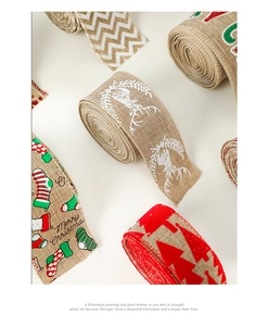 Macro detail of faux linen Christmas ribbons with festive elk and snowflake patterns