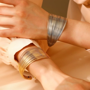 Fashionable layered multi-strand open wide cuff bracelet in gold and silver finishes