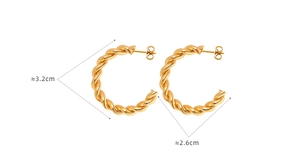 Macro detail of gold-plated stainless steel twist earrings showing 3.2cm outer diameter