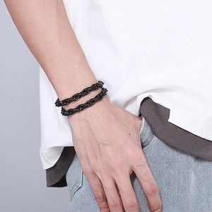 Men's black double-layer stainless steel chain bracelet on wrist in street style