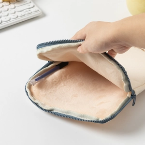 Detail of soft peach-pink plush lining and durable canvas of the laptop sleeve bag