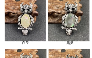 Macro detail of vintage owl brooch pendant with white and black shell inlay craftsmanship