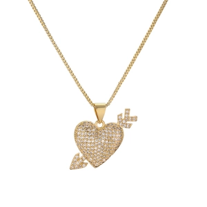 Detailed view of a gold-plated heart and arrow pendant with sparkling crystal inlay