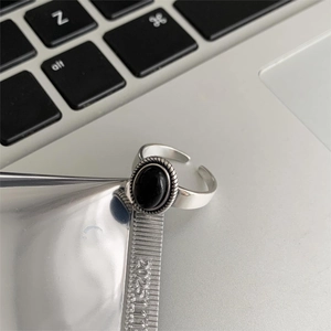 Retro S925 sterling silver ring with black agate and twisted rope texture on a laptop
