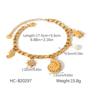 Detail of gold ocean-themed bracelet featuring seahorse, pearl, and sea turtle charms
