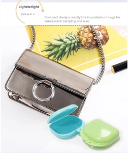 Portable orthodontic retainer case in blue and green on a white travel-ready background