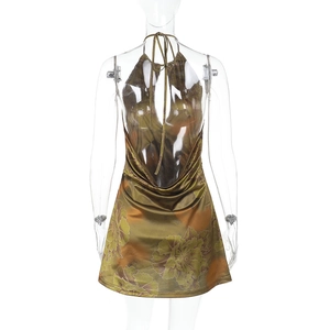 Detail of bohemian floral print and low back design on a halter neck mini dress