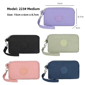 Detail view of nylon wallets in multiple colors with metal zippers and size measurements
