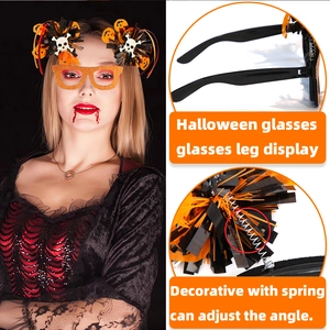 Detail of Halloween party glasses with orange pom-poms and adjustable spring temples