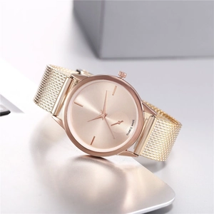 Close-up of rose gold quartz watch featuring a milanese mesh strap and minimal dial