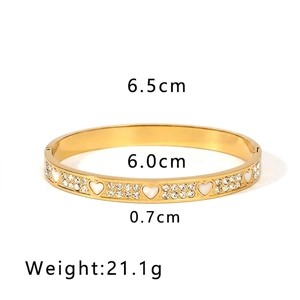 Detail view of 18K gold plated stainless steel bangle with white hearts and crystal pave