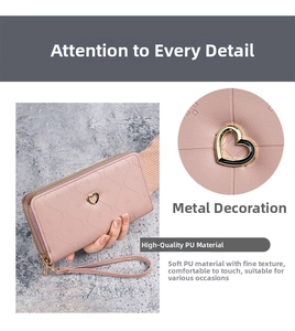 Detail of pink PU leather long wallet with golden heart accent and wrist strap