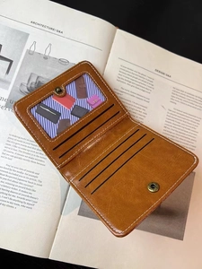 Detailed interior of a brown PU leather wallet featuring card slots and clear ID window