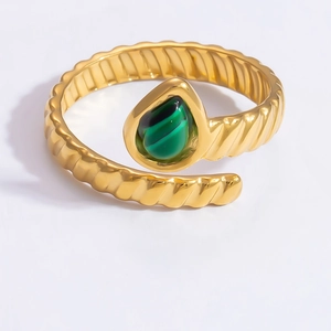 Detailed shot of an adjustable gold textured ring featuring a green teardrop malachite stone