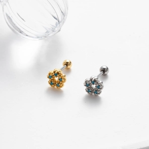 Detail of flower stud earrings with blue beads and screw back in gold and silver finish