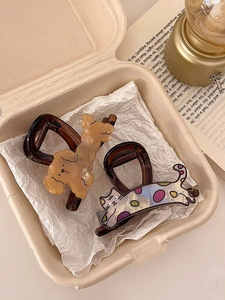 Detail of cute puppy and kitty hair claws in a gift box with a cozy vintage aesthetic
