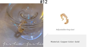 Detail of adjustable gold ring with wave pattern baguette-cut cubic zirconia crystals
