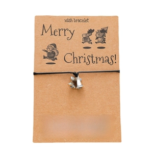 Christmas wish bracelet featuring black woven ropes with silver bell charms on a card