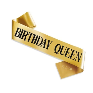Golden silk birthday queen sash with black lettering and safety pin for parties