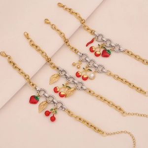 Detail of fruit charms stainless steel bracelets with strawberry and cherry pendants