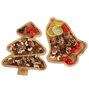 Set of two Christmas tree and bell shaped wooden trays for nuts and festive snacks