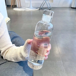 Transparent plastic water bottle with time markers and leak-proof lid for fitness
