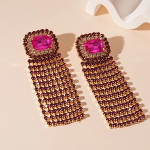 Detail of luxury rose pink rectangular stone earrings with gold tassel fringes