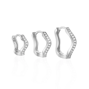 Detailed view of three pairs of silver wavy hoop earrings with inlaid clear zircon stones