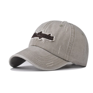 Detailed view of Los Angeles 3D embroidery and distressed holes on vintage wash baseball cap
