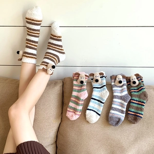 Detail of coral fleece winter socks with cute 3D cartoon dog ears and colorful stripes