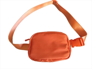 Close-up of orange waterproof nylon waist bag with adjustable strap and buckle closure