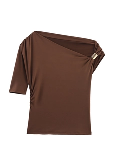 Close-up of side pleats and golden metal ring detail on dark brown asymmetric top
