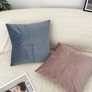 Morandi velvet pillow covers with 'Love rewards the brave' embroidery in a cozy home setting