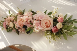 Floral arrangement with pink roses and hydrangeas for wedding table or arch decor