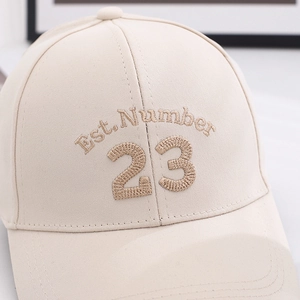 Close-up of beige baseball cap featuring high-quality Est. Number 23 embroidery detail