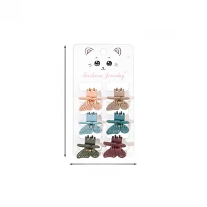 Set of six matte butterfly hair clips in various colors on a fashion jewelry display card