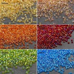 Macro view of 2/3mm iridescent glass seed beads in multiple colors for DIY jewelry