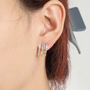 Three-row gold claw earrings with white zircons shown on model for a premium look