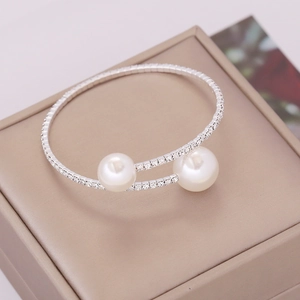 Elegant multi-layer elastic pearl and rhinestone bracelet on a jewelry box