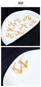 Close-up of minimalist gold-plated geometric earrings in V-shape and hoop designs