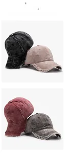 Detail view of washed cotton baseball caps with distressed edges and vintage destruction effect