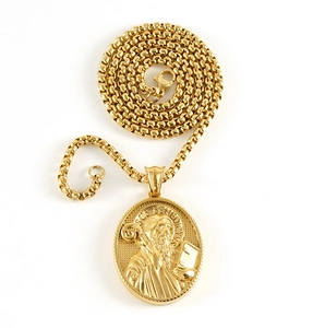 Close-up of golden Saint Benedict 3D relief pendant with detailed box chain necklace
