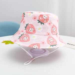 Pink cotton kids bucket hat with rabbit and strawberry prints plus adjustable chin strap