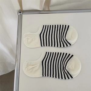 Detailed view of striped low cut cotton socks with black and white horizontal pattern