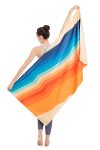 Macro view of a rainbow striped microfiber beach towel with quick-dry fabric textures