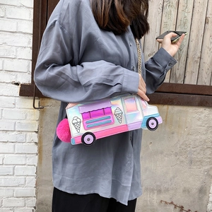 Detail of laser ice cream car crossbody bag with rainbow finish and pink pompom