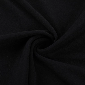 Close-up of black pleated fabric texture with elegant spiral draping detail on the dress