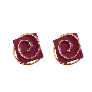 Vintage burgundy square stud earrings with golden spiral texture on white background