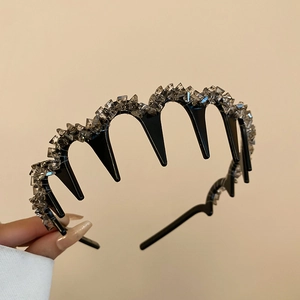 Close-up of wavy non-slip headband with shimmering rhinestones and black tooth comb