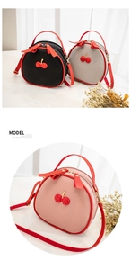 Detail of lychee pattern leather crossbody bags with sparkling cherry accents and bows